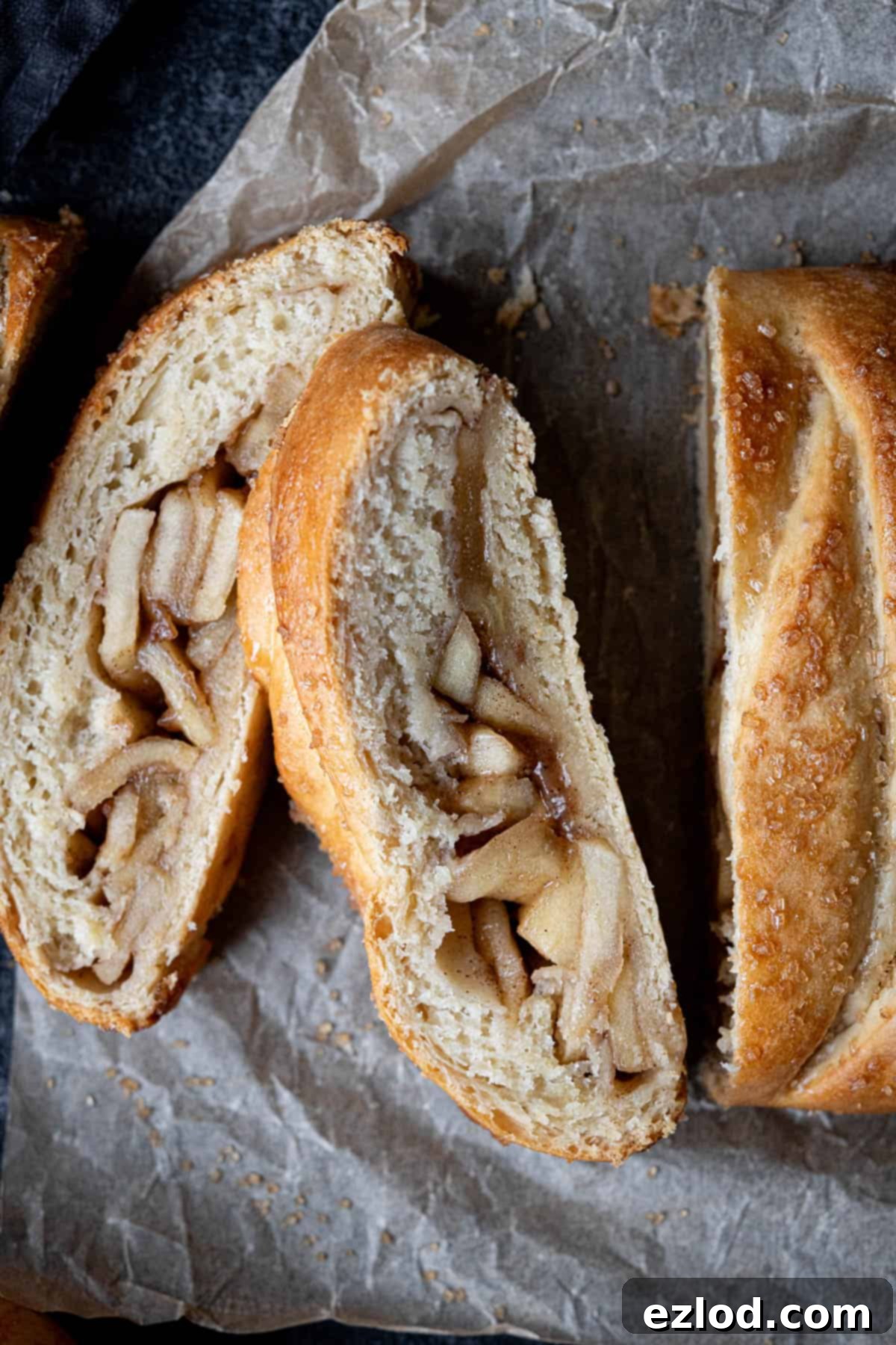 Spiced Apple Vegan Brioche 4 Close up of a single slice of vegan apple brioche, showing the intricate layers of dough and apple filling.