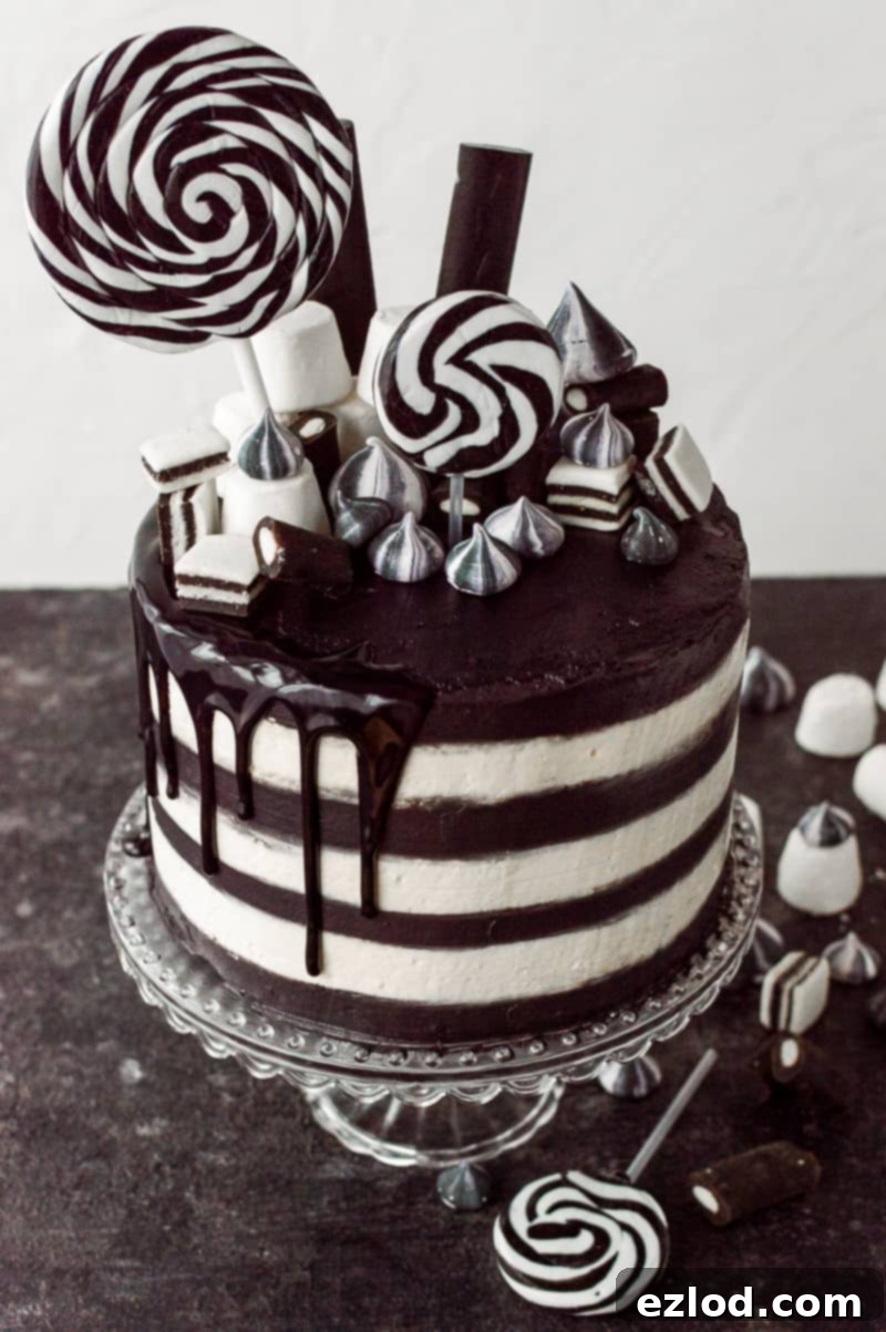 Black and white sriped cake topped with black and white sweets.
