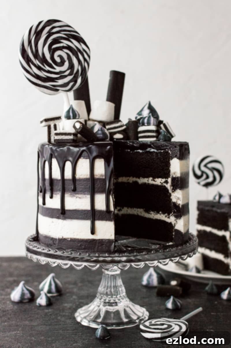 Black and white stripy Halloween cake with black and white meringue kisses.