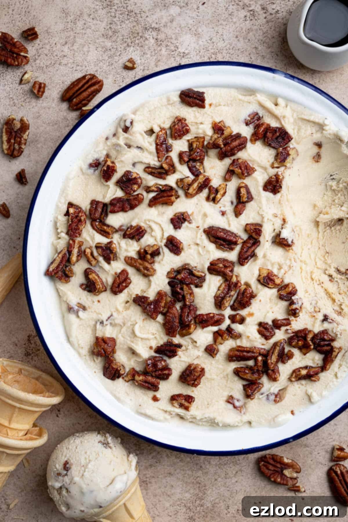 Close up of vegan maple pecan ice cream in a round container.