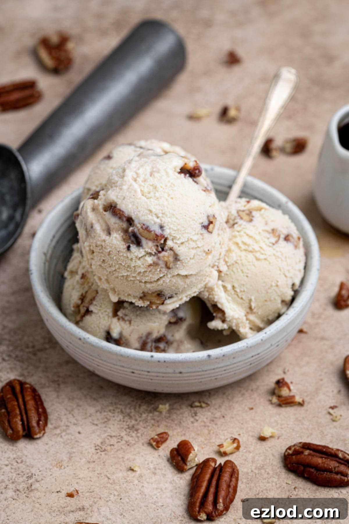 Scoops of vegan maple pecan ice cream in a bowl.