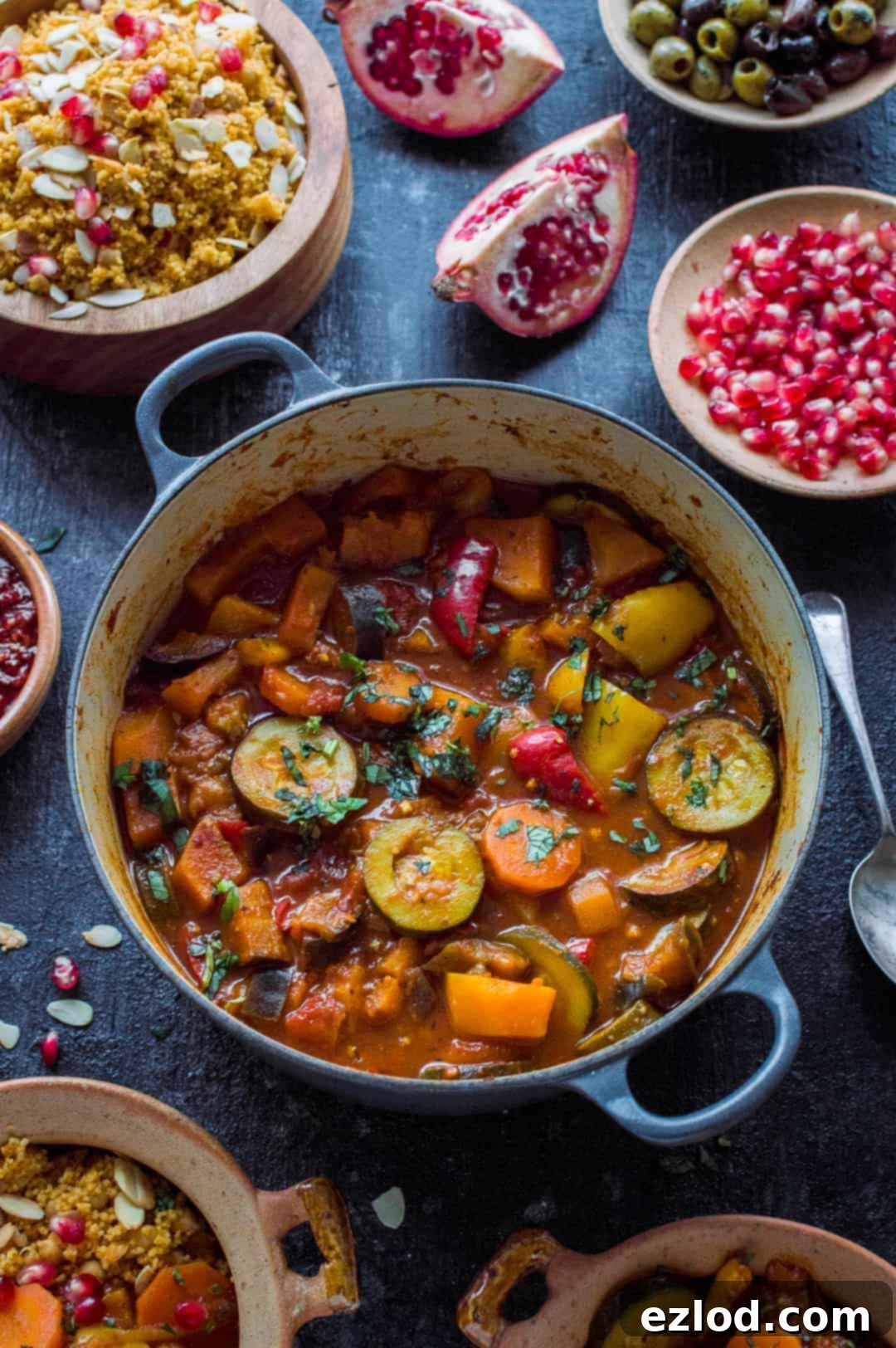 A close-up view of the vegan vegetable tagine, showcasing its rich texture and diverse ingredients including tender aubergine, courgette, carrots, butternut squash, and vibrant bell peppers. A truly wholesome and satisfying plant-based dish.