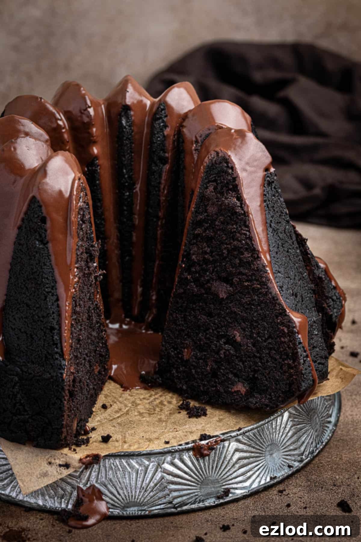 Decadent Vegan Chocolate Bundt Cake 11 A close-up view of a perfectly sliced bundt cake, showcasing its rich chocolate color and moist, fluffy texture.