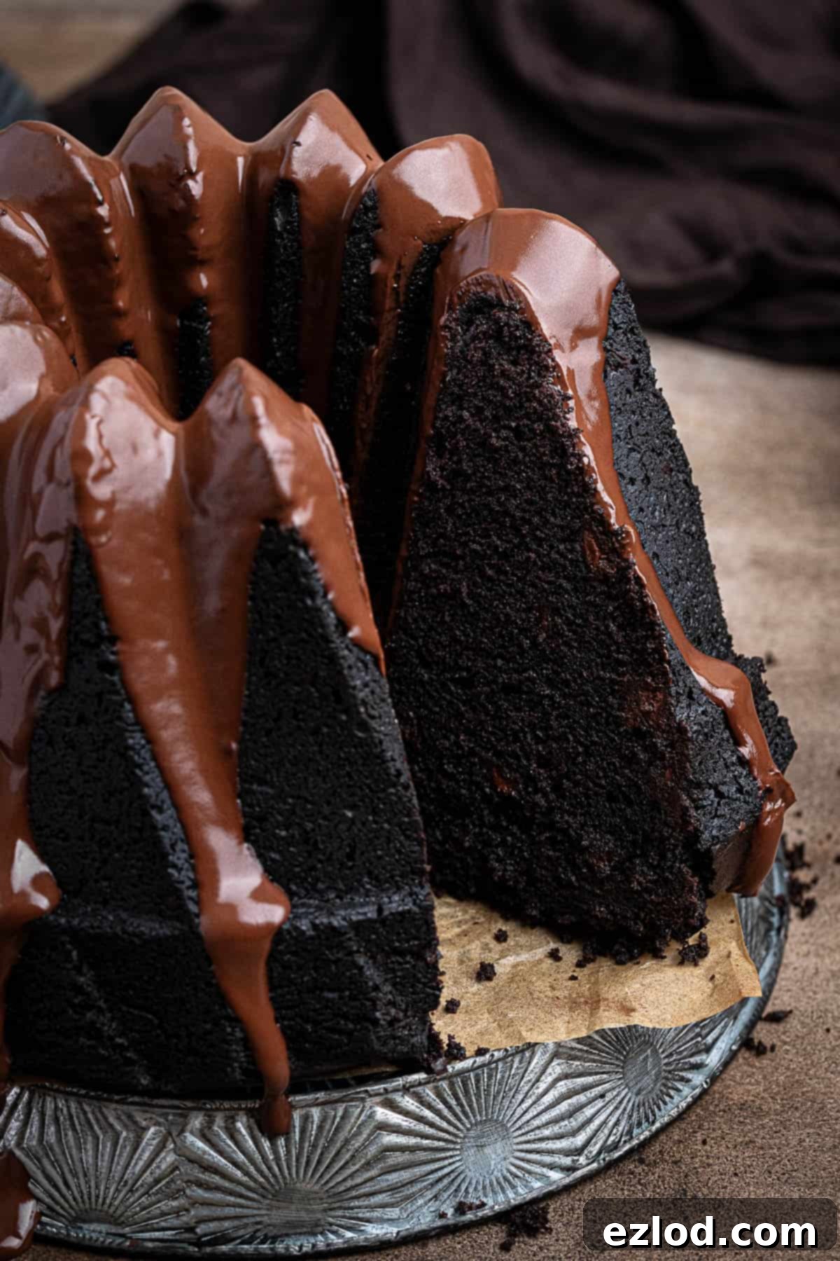 Decadent Vegan Chocolate Bundt Cake 4 A close-up view of a perfectly sliced vegan chocolate bundt cake, revealing its incredibly moist and tender crumb, ready to be enjoyed.