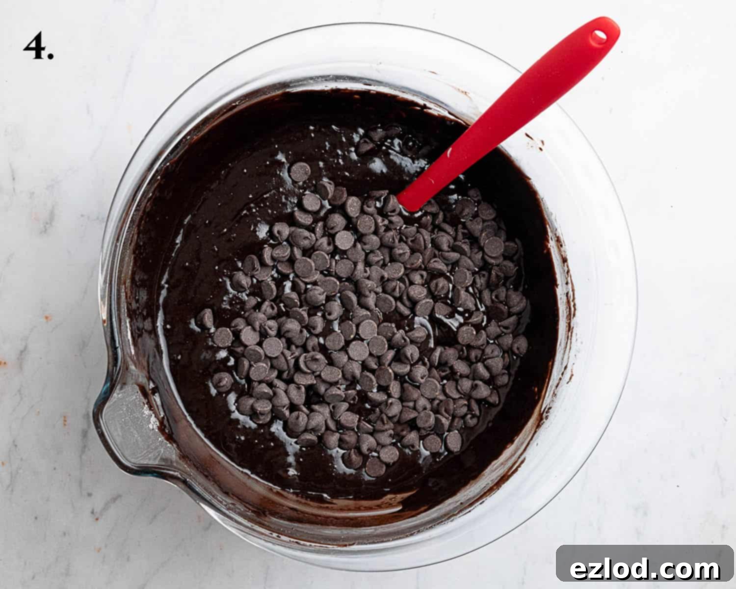 Decadent Vegan Chocolate Bundt Cake 8 Step 4 of the vegan chocolate bundt cake process, displaying the smooth, finished batter with chocolate chips folded in, ready for baking.