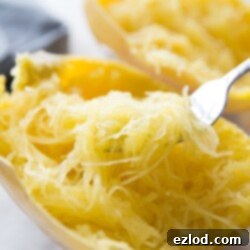 How to Prep Spaghetti Squash with Recipes 6 Spaghetti squash cooked and shredded, with a fork, ready to be served