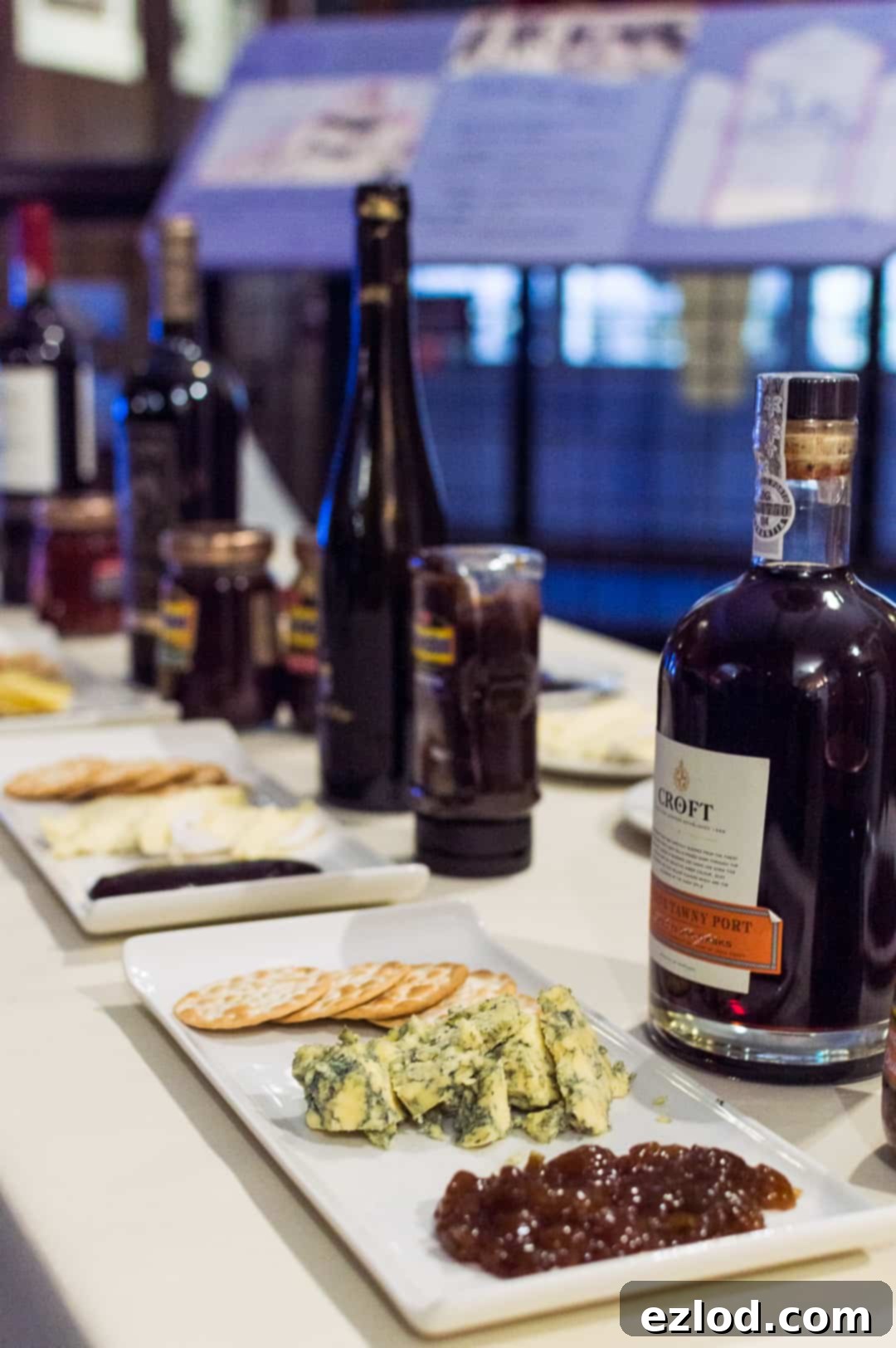 A selection of cheeses, wines, and Branston pickles and chutneys laid out for tasting