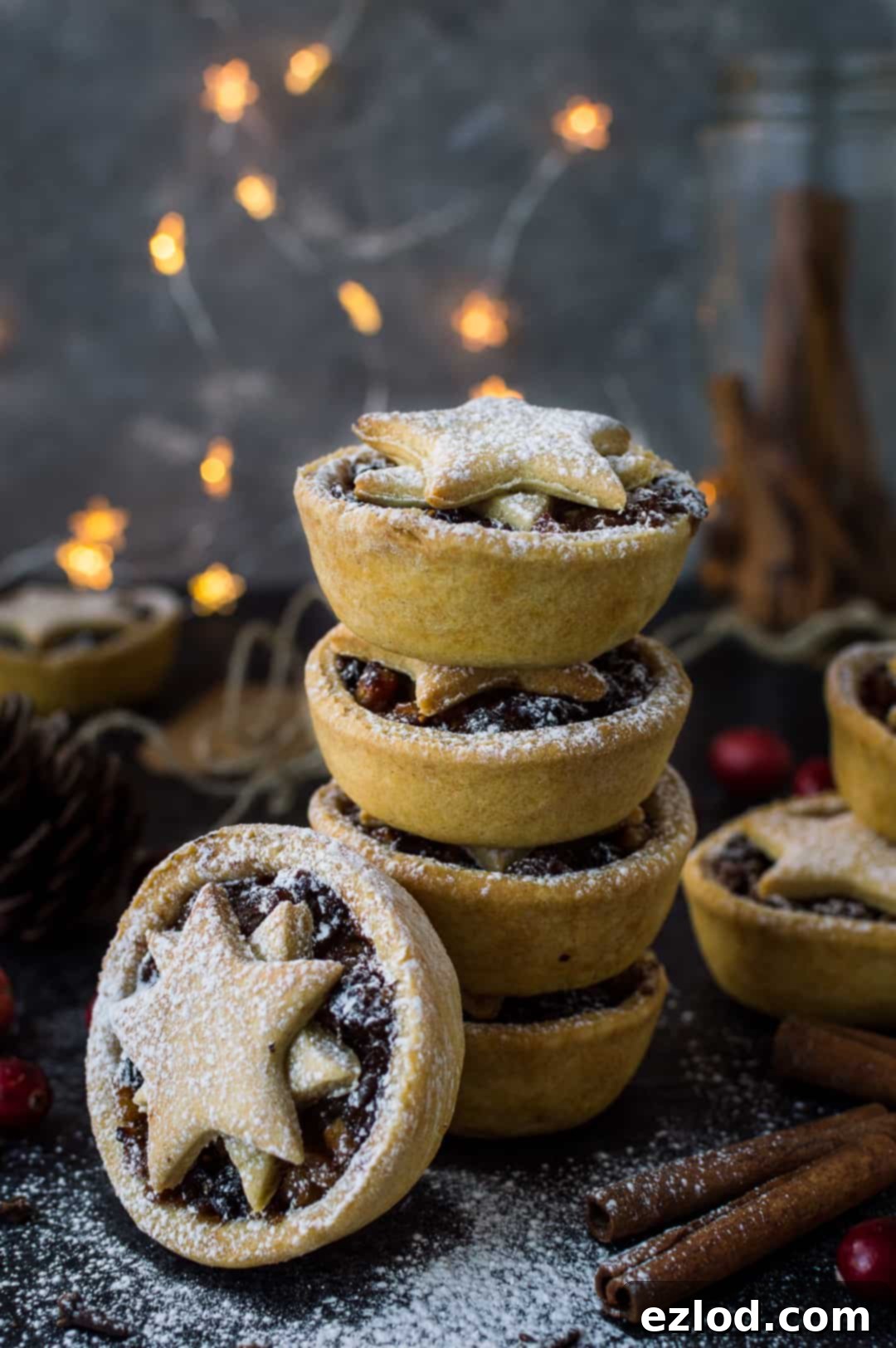 Guilt-Free Vegan Mince Pies 7 Photograph of a stack of lower calorie vegan mince pies with fairy lights in the background.