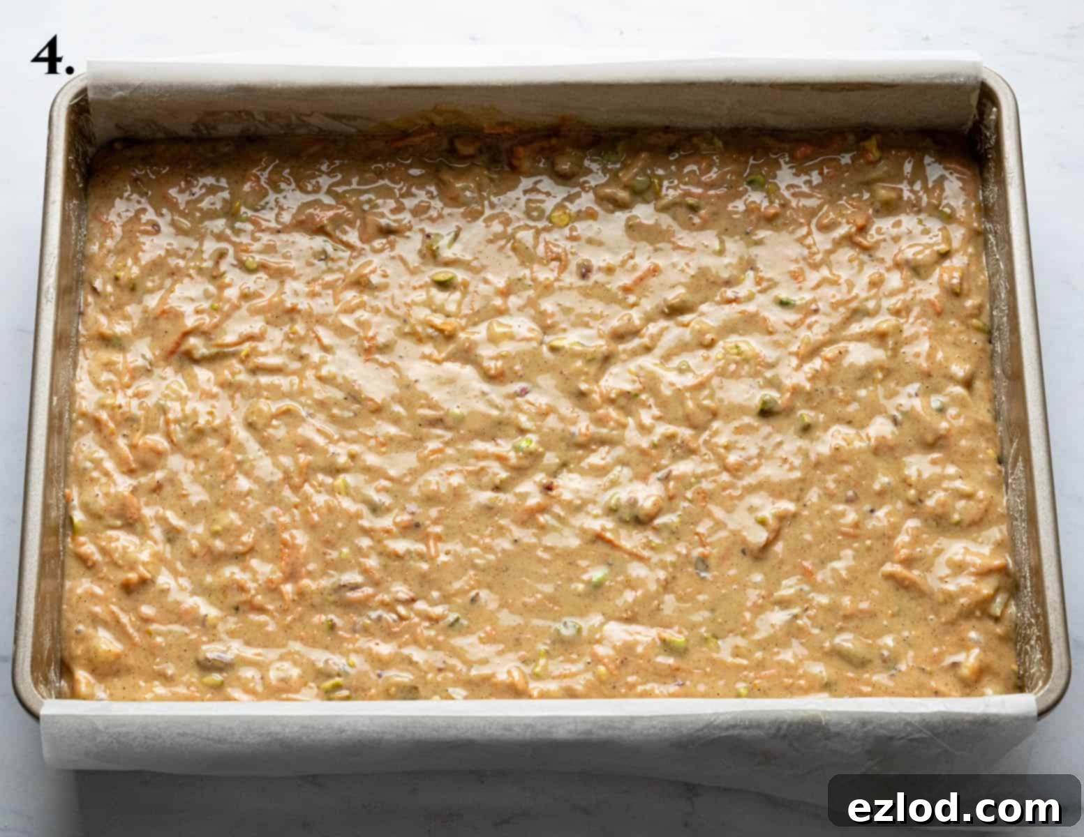 Step 4: The vegan carrot cake batter poured into a traybake tin, ready for baking.