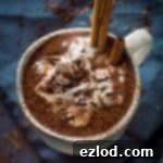 Thick, creamy vegan gingerbread hot chocolate - rich and lusciously thick vegan hot chocolate with gingerbread spices. Made with cashews, sweetened with dates; refined sugar free.
