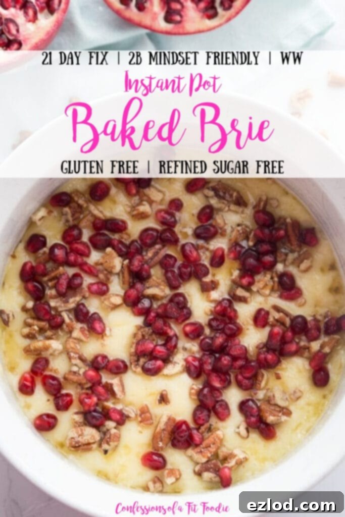 Overhead photo of a white ceramic bowl of melted brie with pomegranate seeds, honey and pecans. Two pomegranate halves sit nearby. There is the text overlay- 21 Day Fix | 2B Mindset Friendly | WW | Instant Pot Baked Brie | Gluten Free | Refined Sugar Free | Confessions of a Fit Foodie