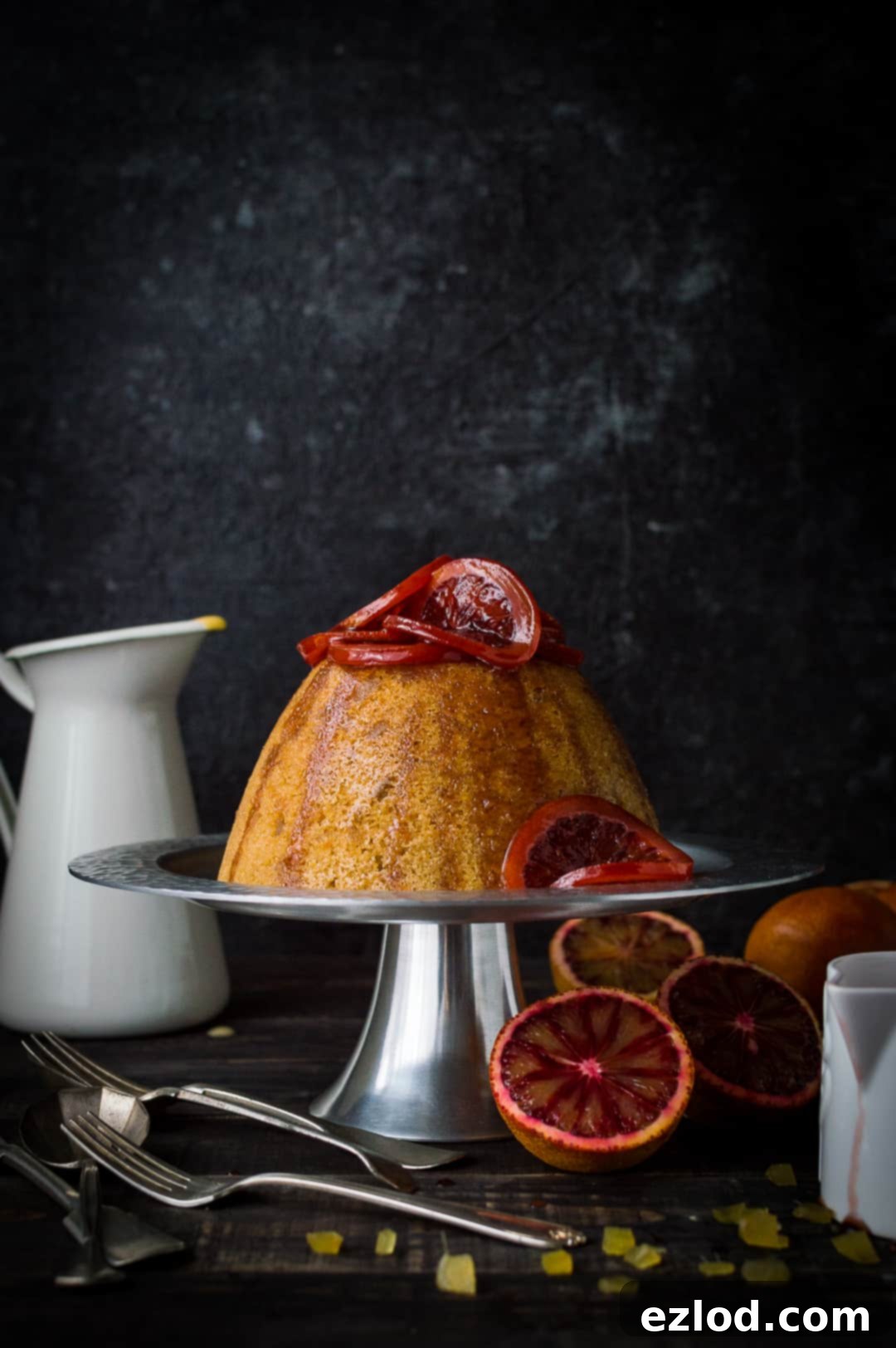A beautifully plated slow cooker blood orange and ginger steamed pudding, perfect for cozy winter evenings.
