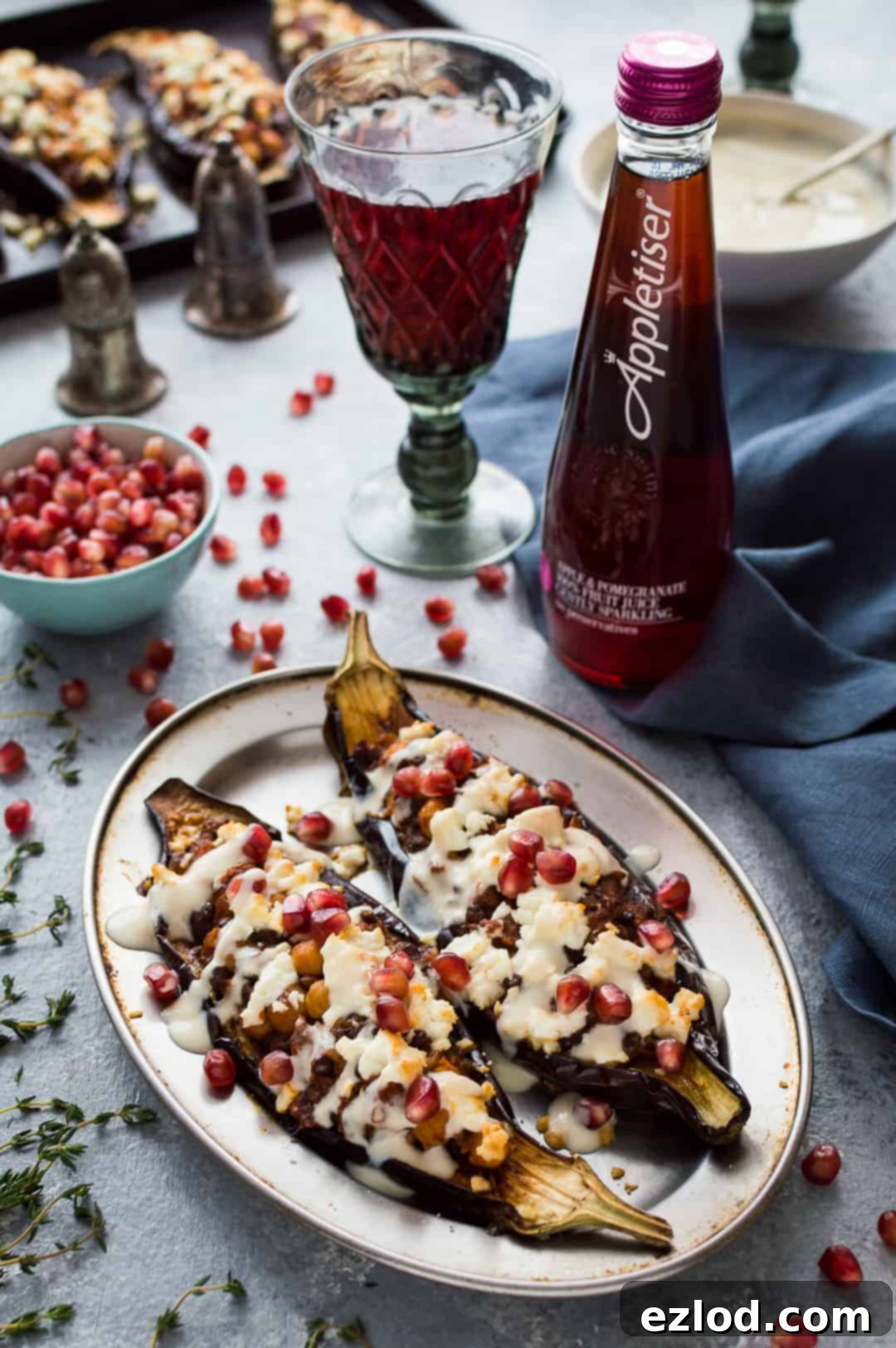 Vegetarian chickpea and lentil stuffed aubergines with lemon tahini sauce and feta.