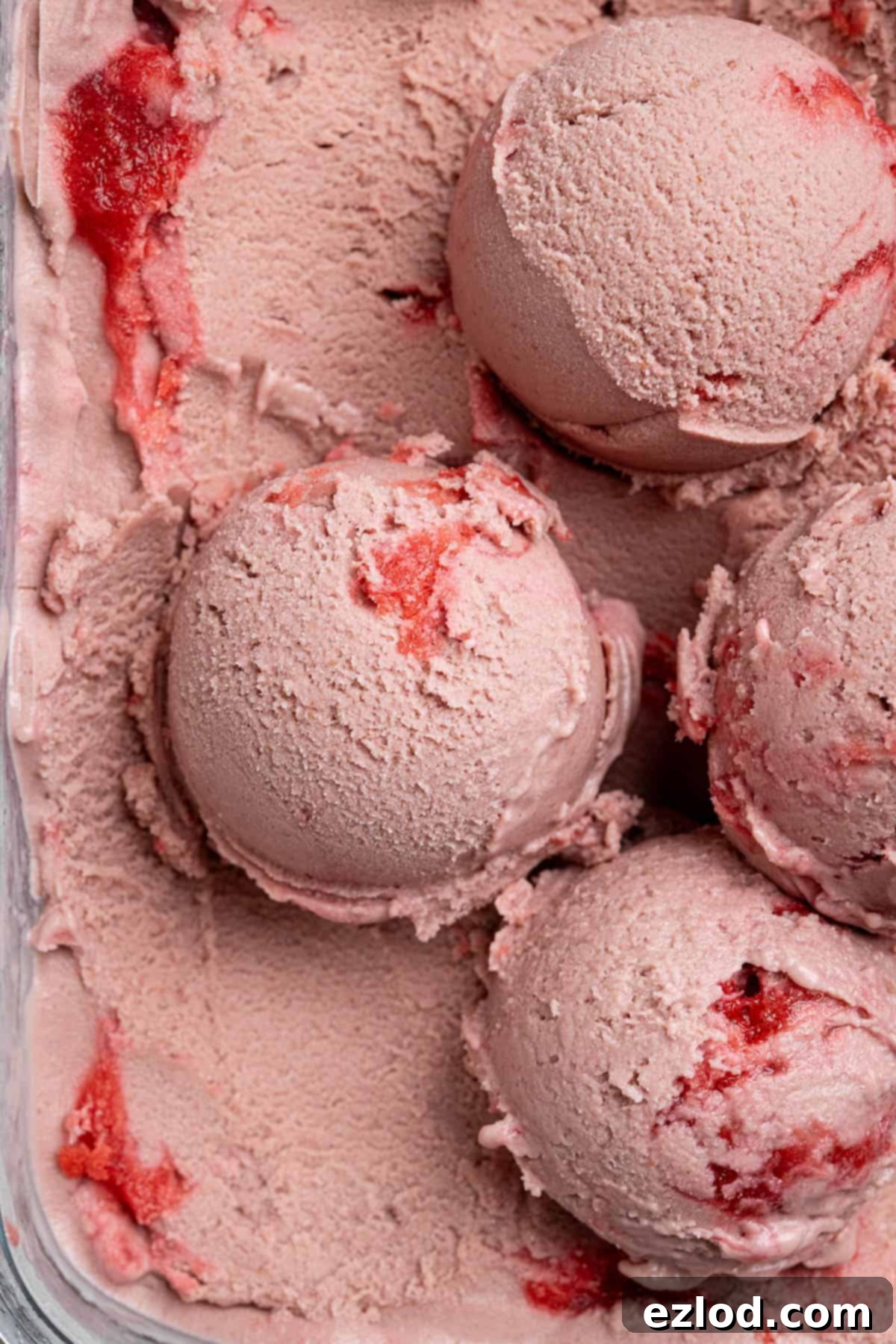 Close up of scoops of vegan strawberry ice cream.