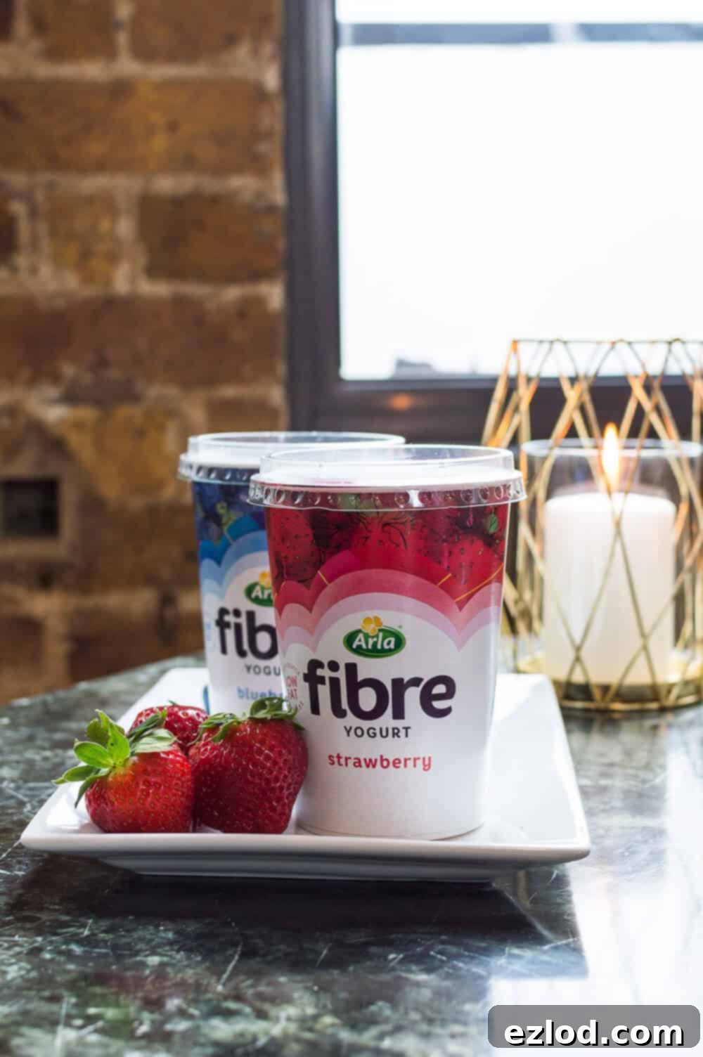 A pot of Arla Fibre strawberry yogurt, showcasing a tasty and easy way to add fibre to your diet.