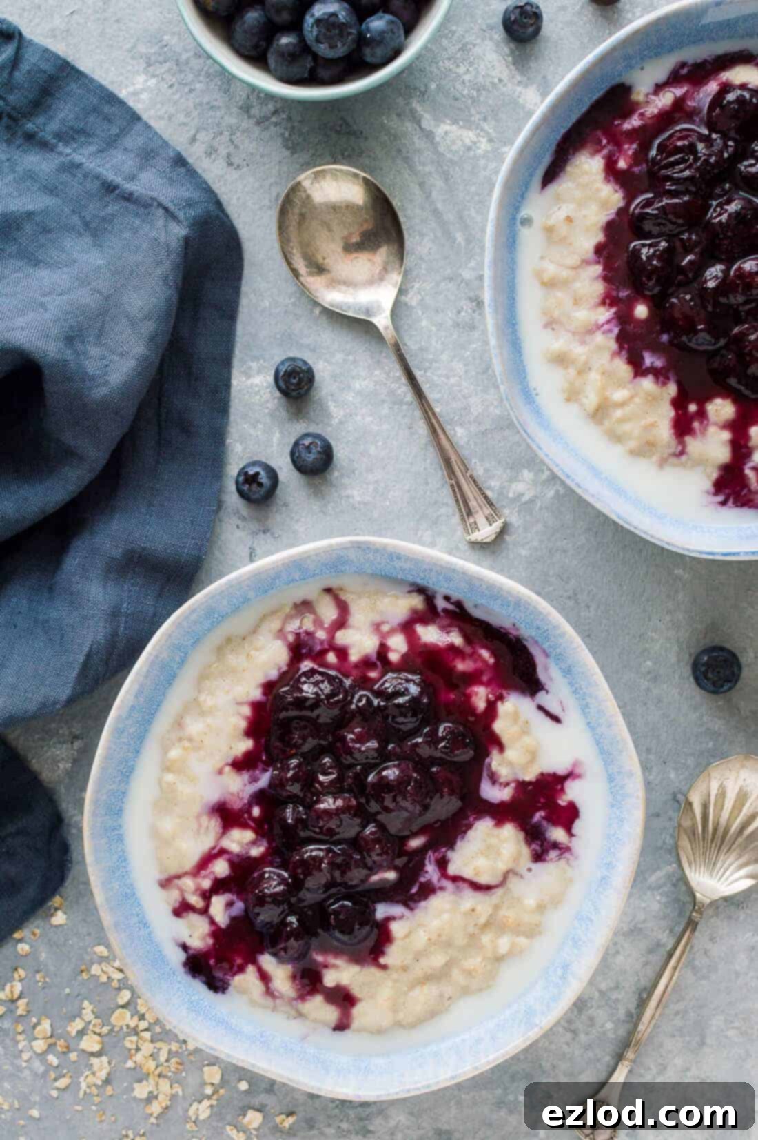 Golden Banana Oats with Blueberry Swirl 2 Creamy banana porridge topped generously with a vibrant blueberry compote, showcasing a healthy and easy breakfast. Perfect for a nutritious start to your day. #oatmeal #breakfast #porridge #healthy #veganfriendly