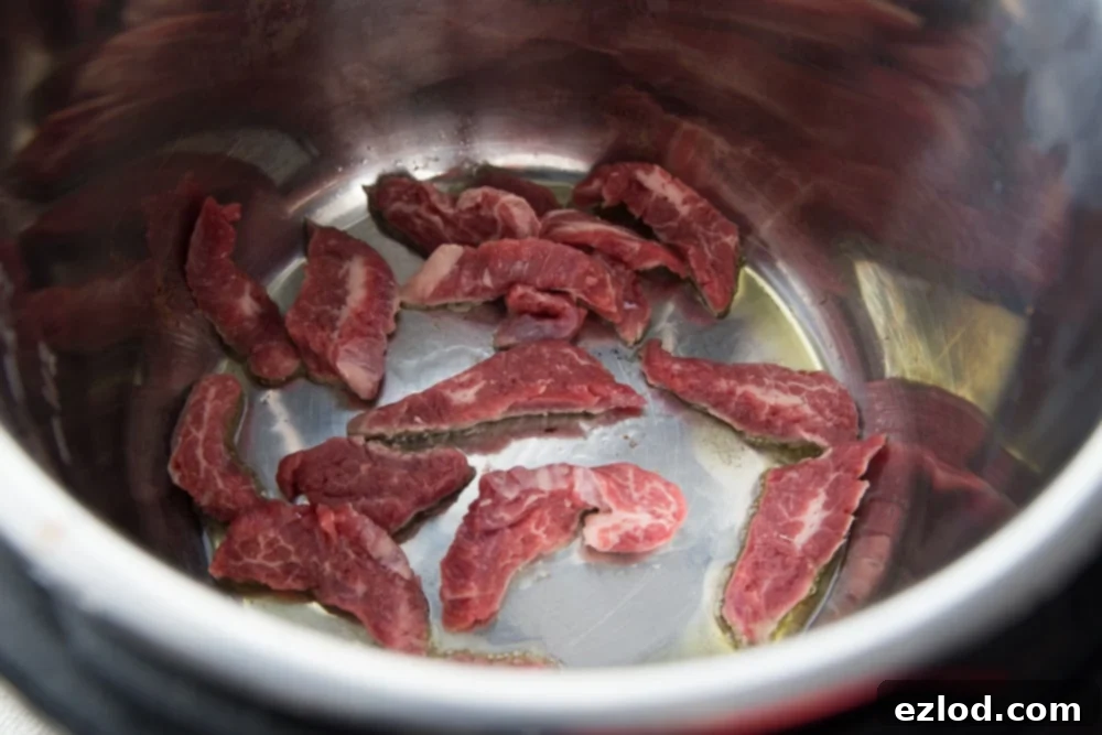 Tender Asian Steak Lettuce Wraps Instant Pot and Slow Cooker 4 Instant Pot with raw flank steak ready for cooking.
