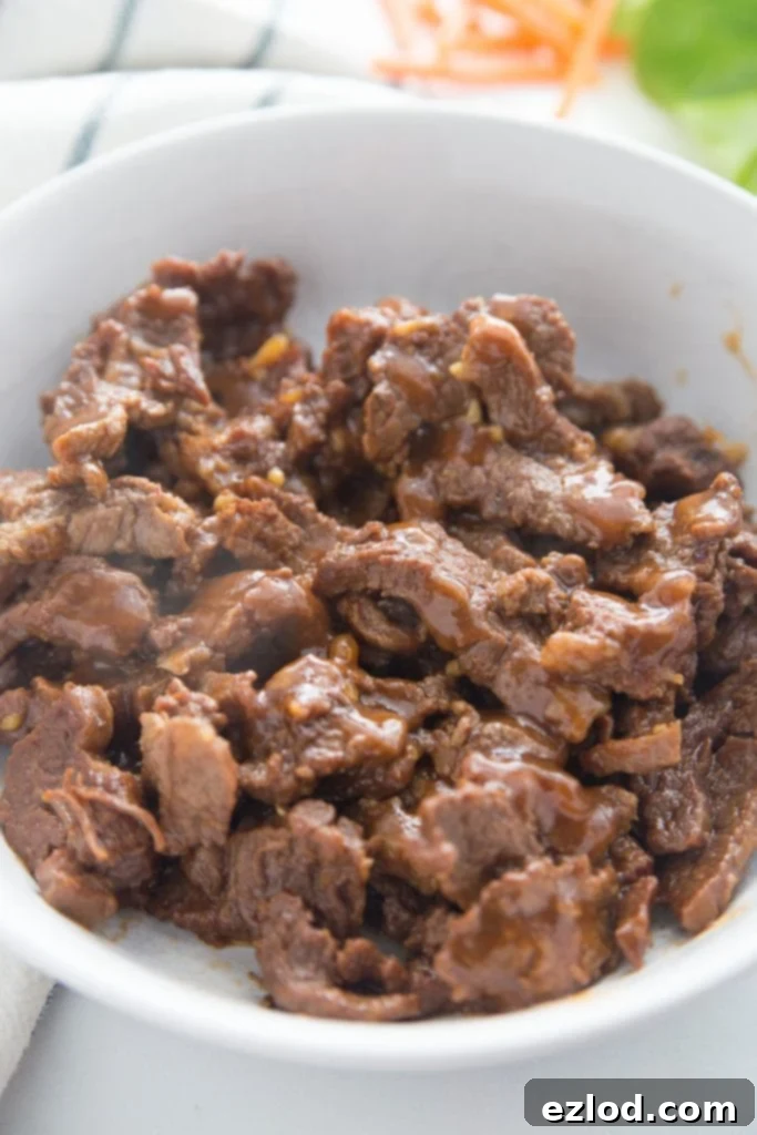 Tender Asian Steak Lettuce Wraps Instant Pot and Slow Cooker 6 A bowl of Instant Pot Asian flank steak with savory sauce.
