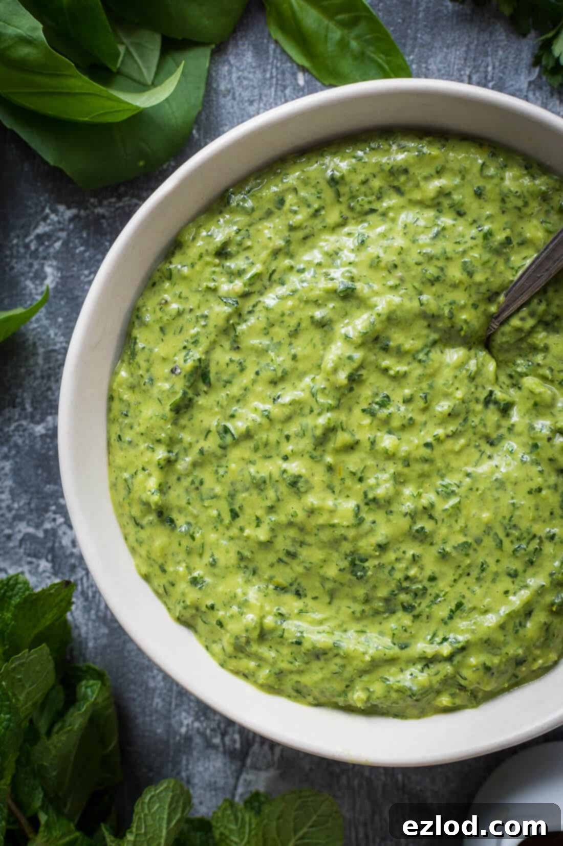 close up of a bowl of green tahini herb dressing