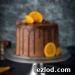 Orange and almond cake with chocolate buttercream - three layers of moist, flavourful vegan orange and almond cake with vegan chocolate orange buttercream, chocolate drip and candied orange slices. Easy to make and perfect for celebrations!