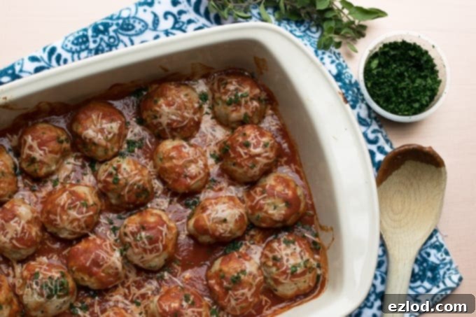Turkey meatballs, lined in a baking dish covered in sauce