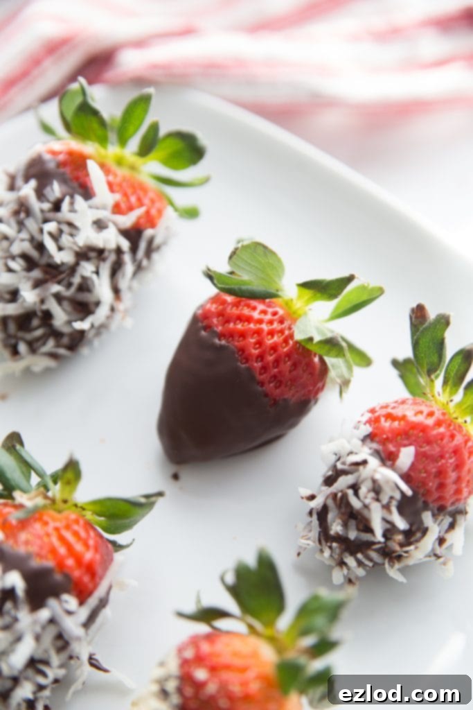 A plate of chocolate covered strawberries with various toppings
