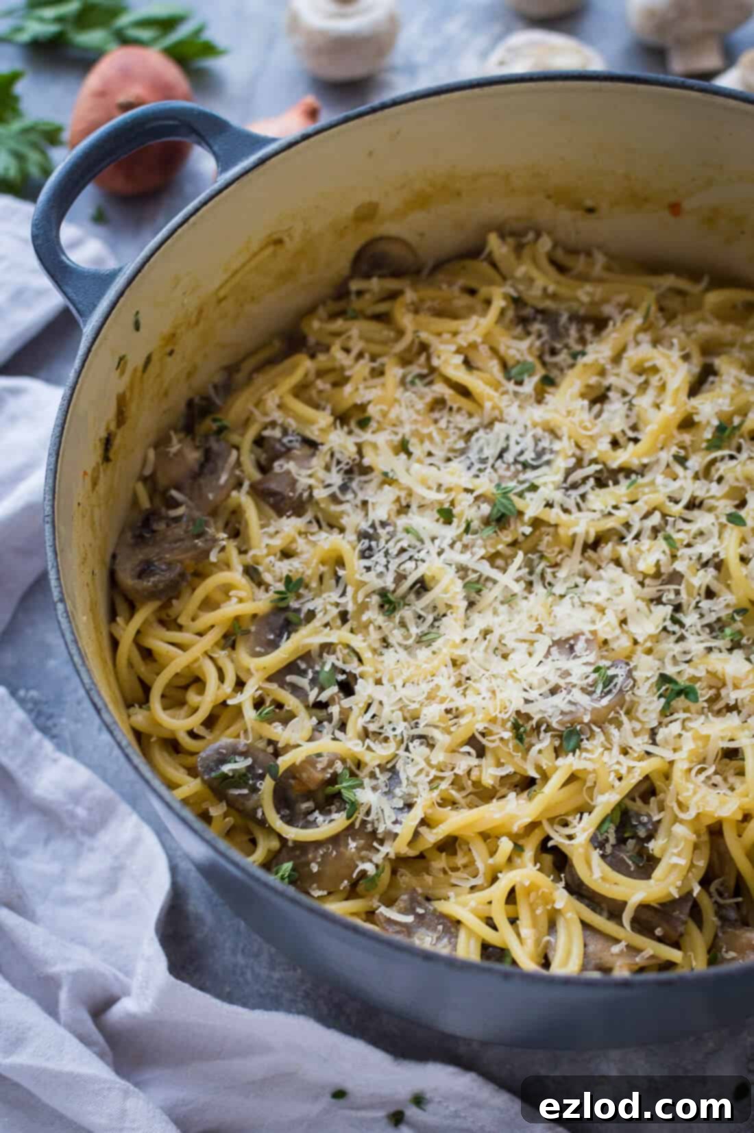 one pot mushroom pasta in a grey pan topped with vegan parmesan