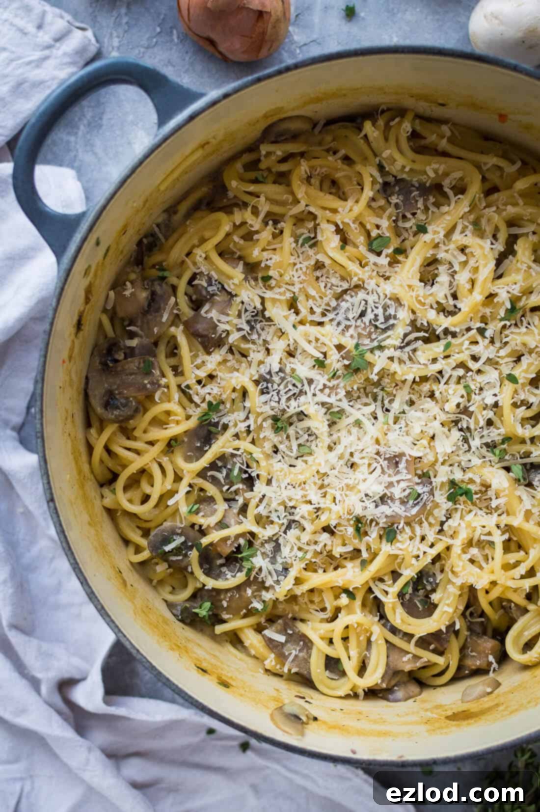 Pot of vegan mushroom pasta topped with vegan parmesan