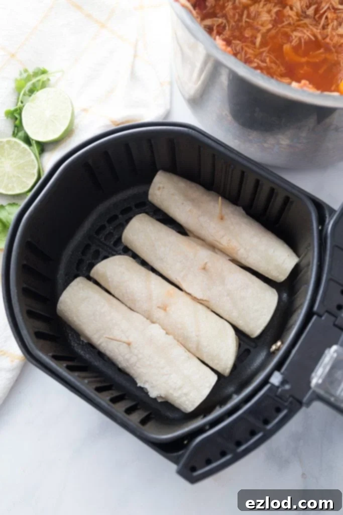 Uncooked Air Fryer Chicken Taquitos, neatly rolled and ready for cooking, showing the simplicity of prep before achieving their perfect crunch.