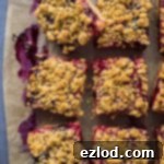Vegan berry oat crumble bars with mixed berries and raspberry jam