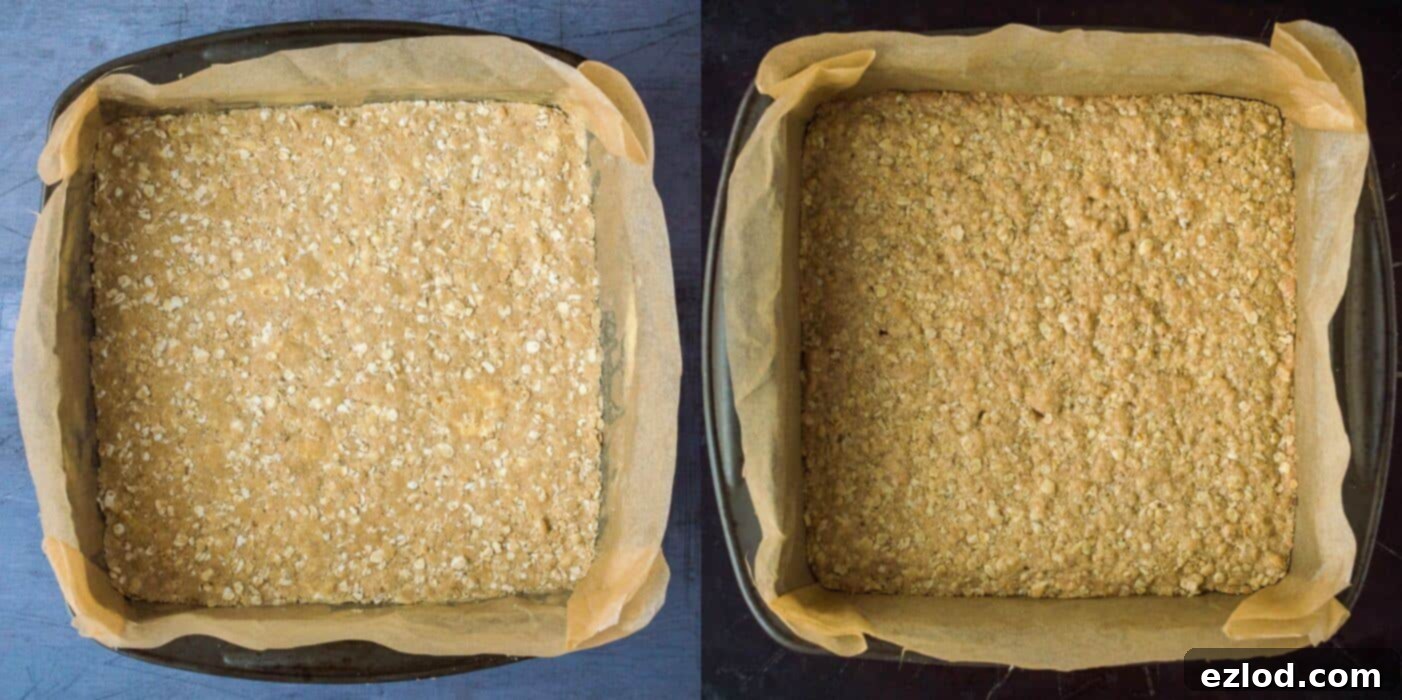 Step 2 in making berry crumble bars: baked golden-brown oat base in a square baking tin.