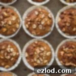 Top down photo of a tray of vegan banana nut muffins.