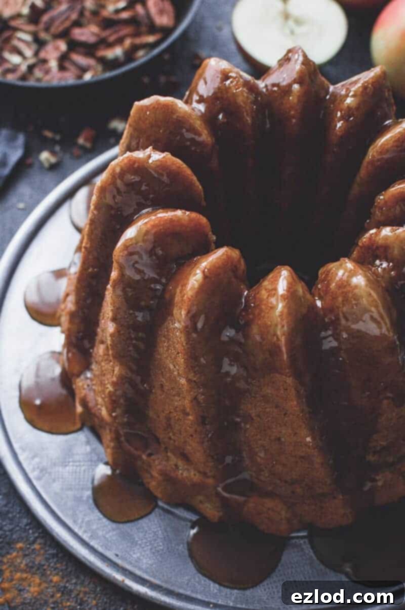 Vegan apple bundt cake - easy to make, moist and lightly spiced, this vegan apple cake is sure to be a hit. Made with both fresh apples and applesauce for the best apple flavour. #vegan #bundtcake #applecake #baking