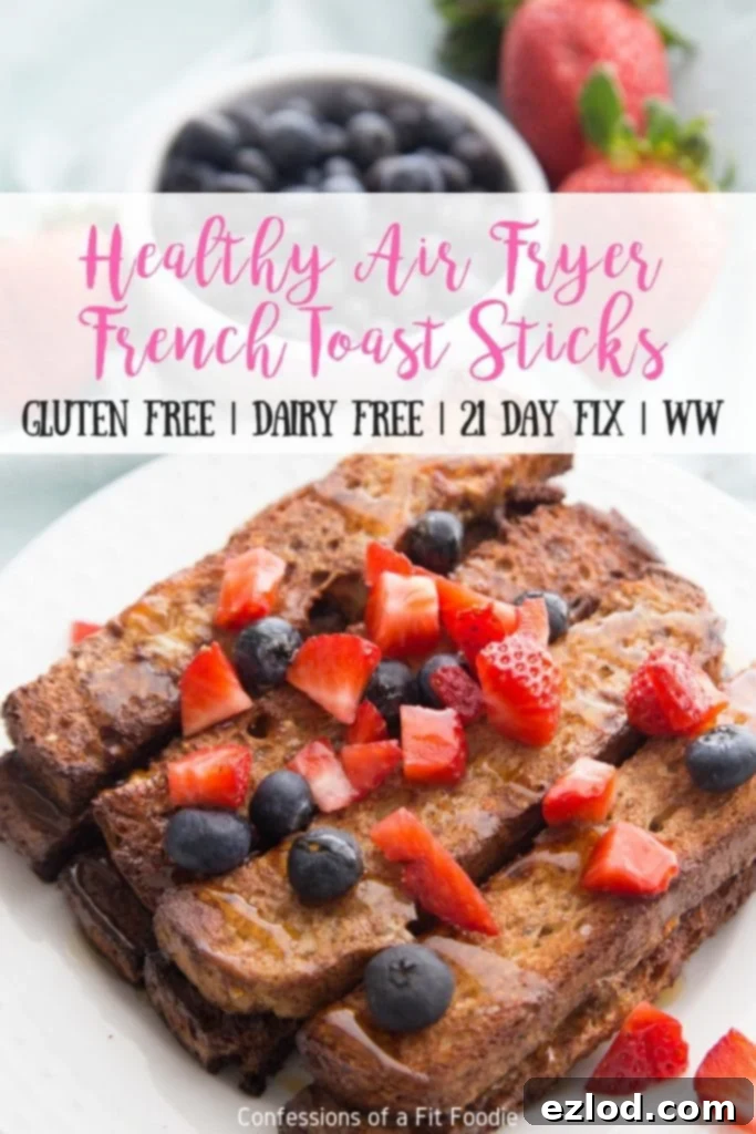 A beautifully arranged plate of golden-brown Air Fryer French Toast Sticks, complemented by a vibrant mix of fresh berries, creating an appealing and healthy breakfast.