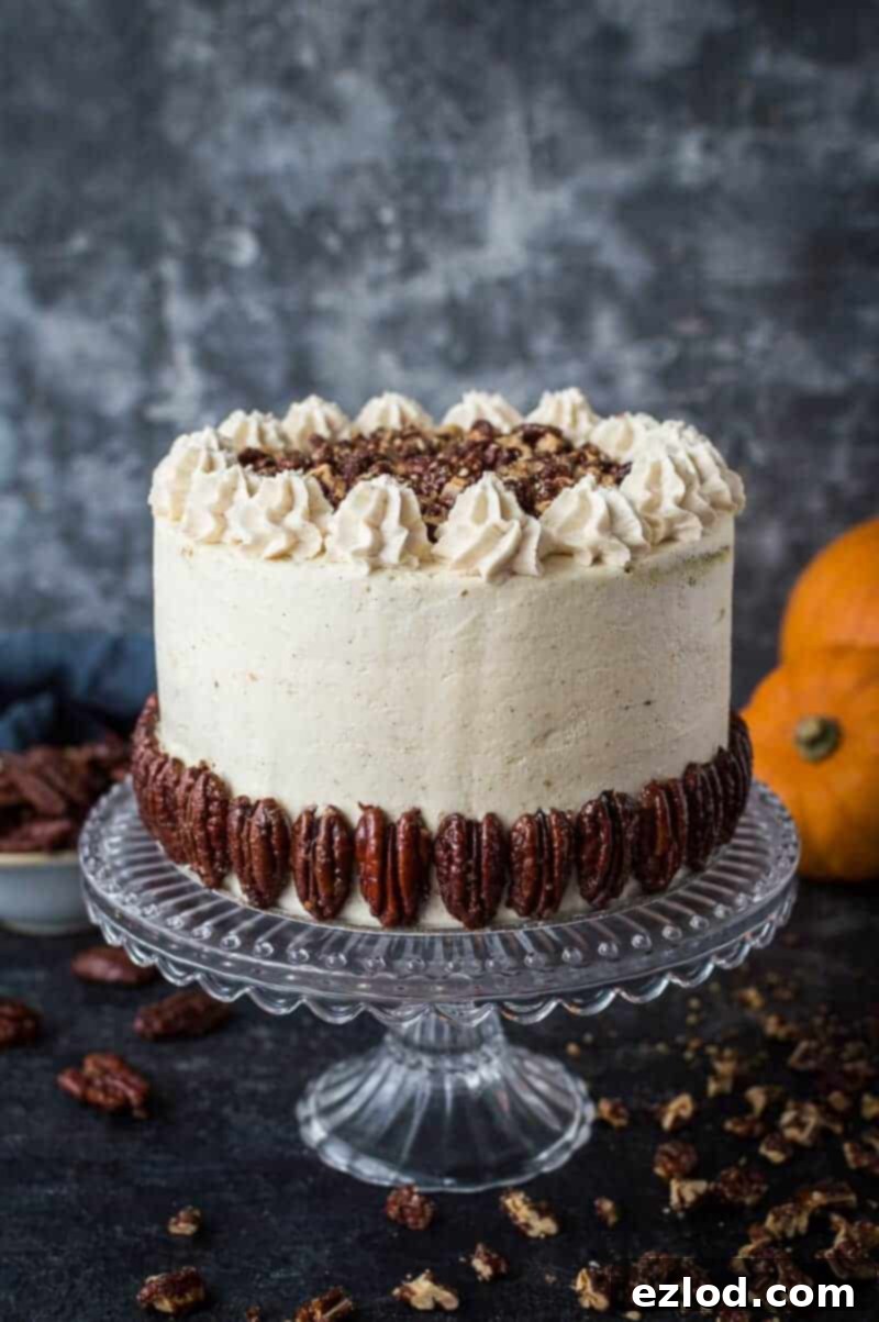 Vegan pumpkin cake with maple pecans and cinnamon buttercream, a perfectly spiced and moist layer cake, ideal for autumn celebrations. #vegan #pumpkinspice #layercake #vegancake #dairyfree