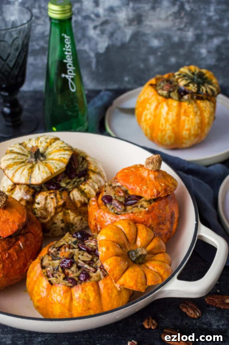 Stuffed mini pumpkins in a cream dish with Appletiser in the background.