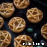 Pentagram topped vegan apple pies for Halloween - these mini vegan apple pies are topped with a pastry pentagram; perfect for Halloween and fans of Supernatural! Step by step instructions included. #vegan #Halloween #applepie