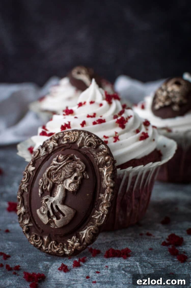 Vegan red velvet cupcake with a chocolate skull cameo with gold detailing for Halloween.