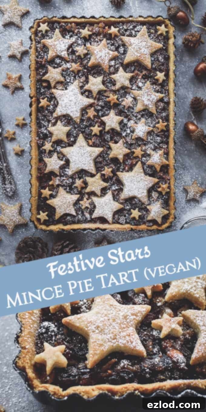 A Pinterest-optimized image featuring the delectable starry mince pie tart, highlighting its festive appeal. This attractive twist on traditional mince pies, filled with vegan-friendly mincemeat and topped with cinnamon shortbread stars, is presented as the perfect holiday centrepiece for Christmas baking.
