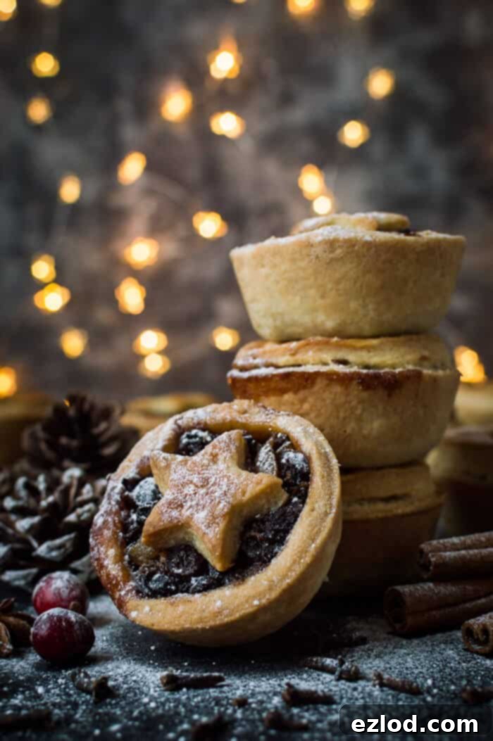A stack of vegan mince pies with fruit filling and coconut oil pastry in a Christmas scene.