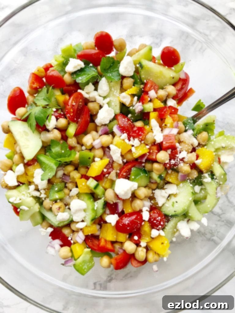 An overhead shot of a vibrant Weight Watchers-friendly Mediterranean Chickpea Salad in a large bowl, showcasing its fresh ingredients and colorful appeal.