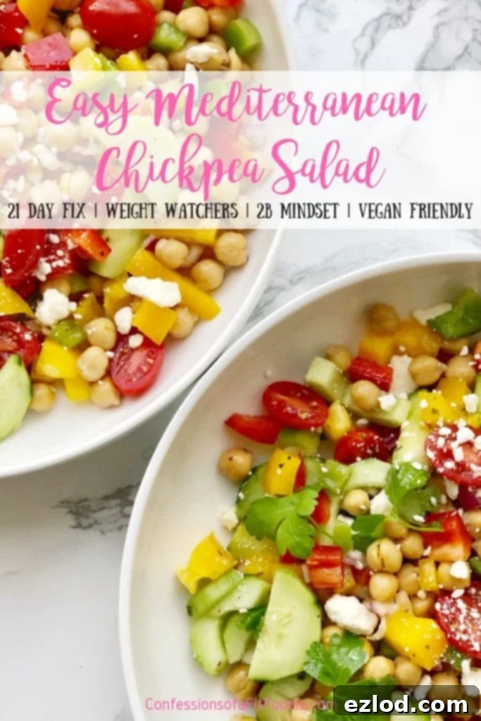 A large bowl of Easy Gluten-free Mediterranean Chickpea Salad, packed with fresh vegetables and chickpeas, ideal for a healthy meal prep or summer potluck, suitable for 21 Day Fix and Weight Watchers diets.