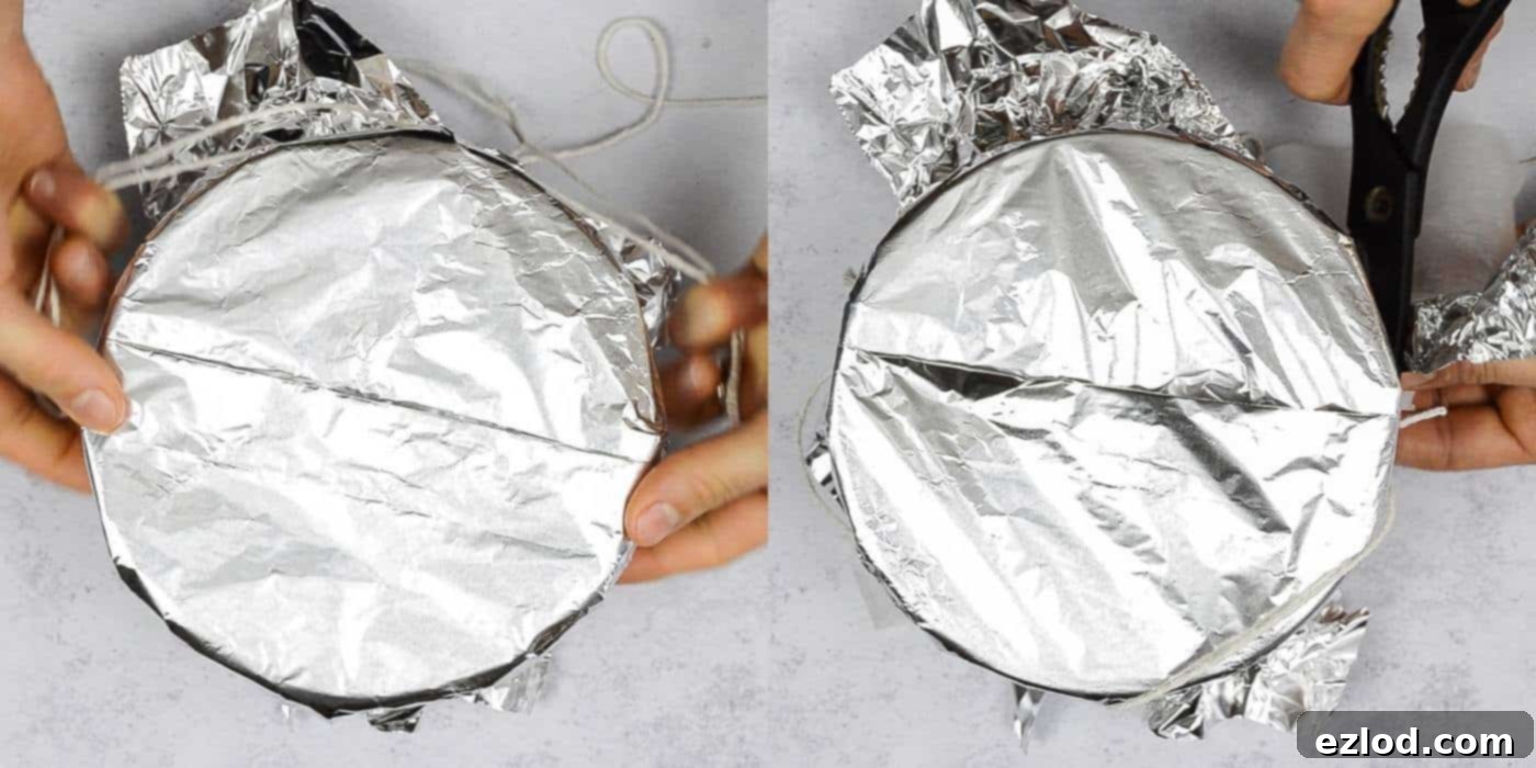 Step 6: Tying kitchen string tightly around the foil-covered pudding basin, creating a secure seal and a handle for easy lifting, then trimming excess materials.