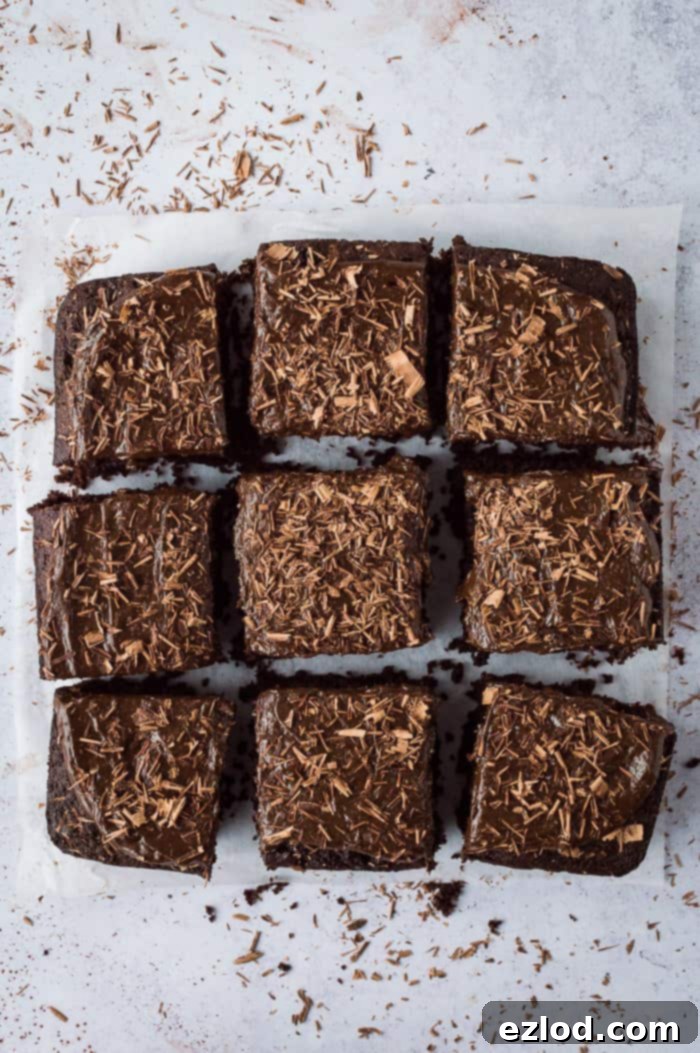 Fudgy Beetroot Chocolate Cake with Avocado Silk Frosting 2 A beautifully sliced vegan beetroot chocolate cake with chocolate avocado frosting, garnished with chocolate shavings, presented in nine perfect squares.