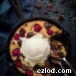 Chocolate raspberry skillet cookie for two - this indulgent vegan skillet cookie is really quick and easy to make, gooey in the middle and crisp around the edges. It is perfect for a romantic Valentine's day dessert to share! #vegan #skilletcookie