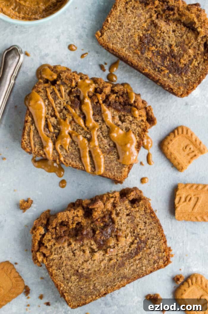 Close-up of individual slices of vegan Biscoff banana bread, showcasing the rich Biscoff cookie butter swirls within the moist bread, topped with a delicate streusel crumble, ready to be enjoyed.