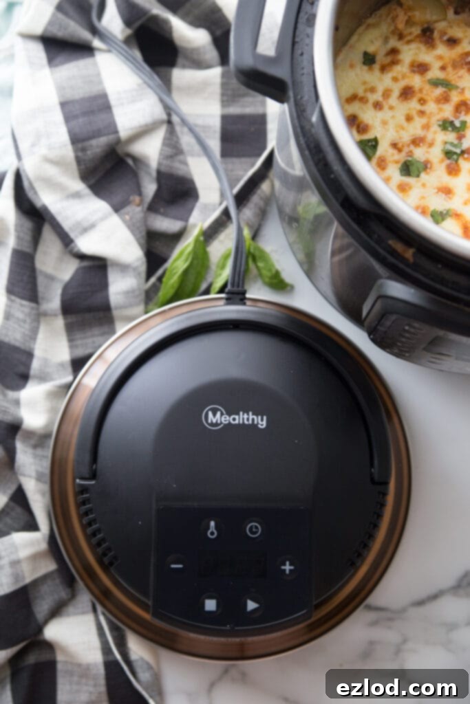 Overhead shot of a Mealthy CrispLid on a white marble countertop and a black and white checkered tablecloth. In the corner, a partial view of a finished Instant Pot Zucchini Lasagna with a nice crispy cheese topping. This image highlights the crispiness achieved with the Mealthy CrispLid for a healthy and easy Instant Pot Zucchini Lasagna, perfect for Keto and 21 Day Fix diets.