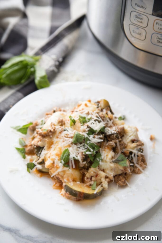 A close-up shot of an Instant Pot Zucchini Lasagna with a perfectly crispy and golden-brown cheese topping, garnished with fresh basil, showcasing the ideal texture achieved with the CrispLid or broiler. Ideal for a healthy, quick, and low-carb meal.