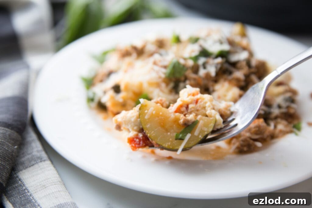 A vibrant, overhead shot of the delicious Instant Pot Zucchini Lasagna served in the Instant Pot liner, showing the rich layers of zucchini, meat sauce, and melted cheese, with fresh basil garnish. This low-carb lasagna is a healthy and quick dinner idea.