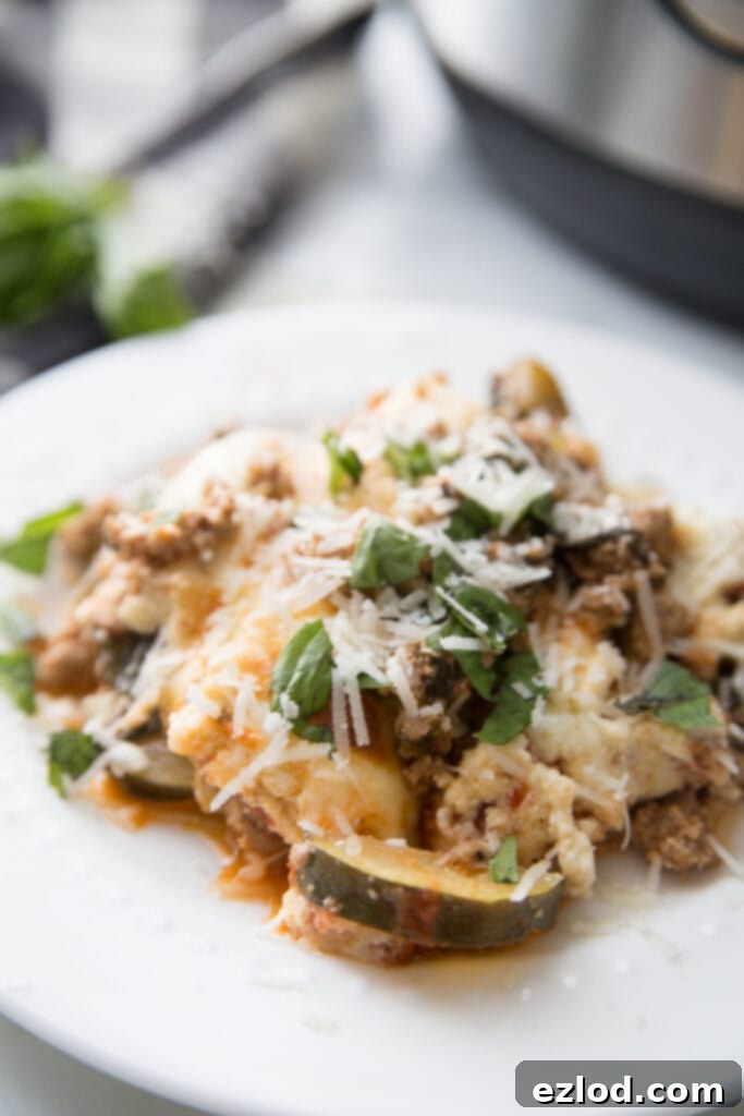A full view of the Instant Pot Zucchini Lasagna served directly in the Instant Pot liner, garnished generously with fresh basil leaves. This image showcases the complete, ready-to-eat low-carb lasagna, emphasizing freshness and ease.